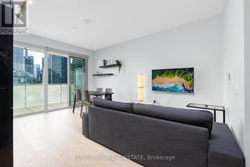 Toronto (Waterfront Communities) condo for rent - A living room with a grey couch and a painting on the wall.