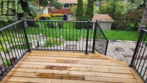 Ottawa apartment for rent - A wooden deck with a metal railing.