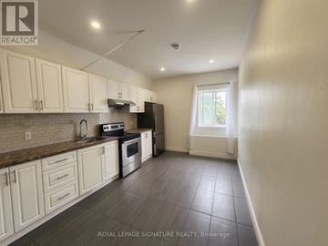 Bradford West Gwillimbury (Bradford) apartment for rent - A kitchen with white cabinets and a tiled floor.