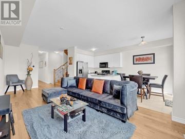 Thorold (Rolling Meadows) townhouse for rent - A living room with a blue couch and a coffee table.