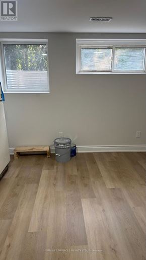Toronto (Cliffcrest) apartment for rent - A room with light wood flooring and two windows.