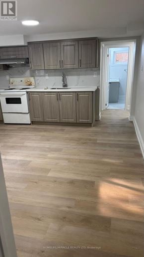 Toronto (Cliffcrest) apartment for rent - A kitchen with wooden floors and a white oven.