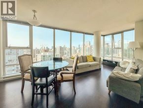 Vancouver apartment for rent - A living room with a table and chairs and a couch.