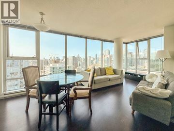 Vancouver apartment for rent - A living room with a table and chairs and a couch.