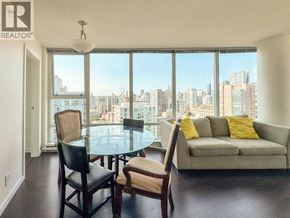 Vancouver apartment for rent - A living room with a glass table and chairs with a city view.
