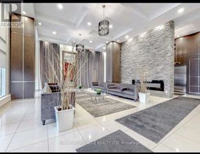 Toronto (Bayview Village) condo for rent - A spacious living room with a stone wall and a grey rug.