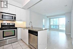 Toronto (Waterfront Communities) condo for rent - A modern kitchen with stainless steel appliances and white cabinets.