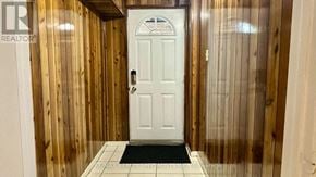Mississauga (Erin Mills) apartment for rent - A white door with a glass window is in a room with wooden walls.