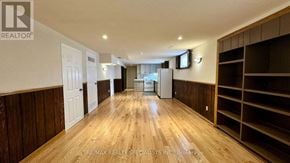 Mississauga (Erin Mills) apartment for rent - A spacious room with wooden floors and built-in shelving.