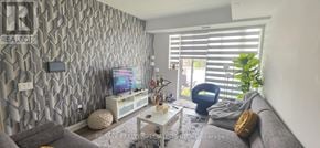 Oakville (Jm Joshua Meadows) condo for rent - A living room with a grey couch and a television.