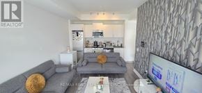 Oakville (Jm Joshua Meadows) condo for rent - A living room with a grey couch and a television.