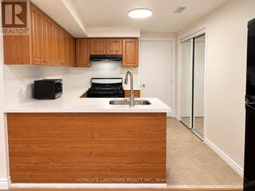 Markham (Cedarwood) apartment for rent - A kitchen with wooden cabinets and a white countertop.