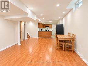Markham (Cedarwood) apartment for rent - A kitchen with a table and chairs in the foreground and a refrigerator in the background.