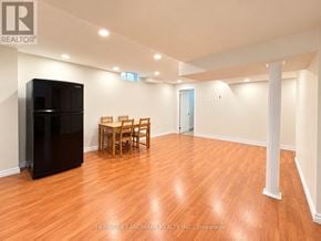 Markham (Cedarwood) apartment for rent - A room with wooden floors and a black refrigerator.