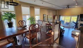 Ramara (Brechin) townhouse for rent - A dining room with a wooden table and chairs.