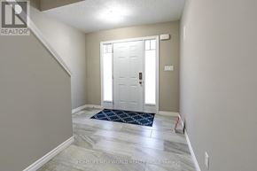 Waterloo townhouse for rent - A hallway with a white door and a blue rug on the floor.