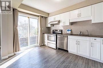 Waterloo townhouse for rent - A kitchen with white cabinets and a stainless steel refrigerator.