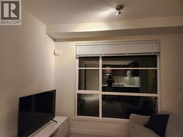 Vancouver apartment for rent - A living room with a television and a window with blinds.
