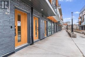 Toronto (Parkwoods-Donalda) townhouse for rent - The image shows a building with a sign that reads "RE/MAX ADVANCE REALTY, Brokerage".