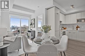 Toronto (Parkwoods-Donalda) townhouse for rent - A modern dining room with a table set for four and a view of the city.