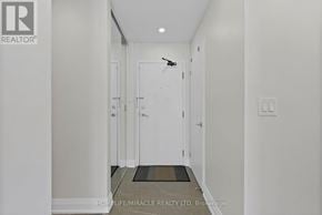 Mississauga (City Centre) condo for rent - A hallway with a door at the end and a sign that says "REALTOR".