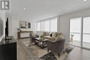 Mississauga (City Centre) condo for rent - A living room with a grey couch, a coffee table, and a flat screen TV.
