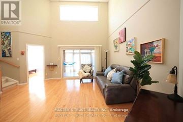 Guelph (Kortright East) townhouse for rent - A living room with a couch and a painting on the wall.
