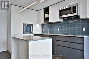 Toronto (Annex) condo for rent - A modern kitchen with a white countertop and a microwave above it.
