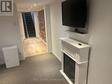 Toronto (Birchcliffe-Cliffside) apartment for rent - A living room with a television and a fireplace.