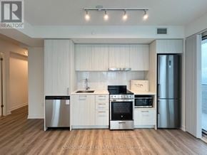 Vaughan (Vaughan Corporate Centre) condo for rent - A modern kitchen with white cabinets and stainless steel appliances.