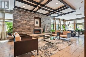 Mississauga (Port Credit) condo for rent - A living room with a stone fireplace and a large couch.