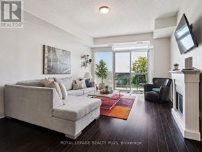 Mississauga (Port Credit) condo for rent - A living room with a grey couch and a red rug.
