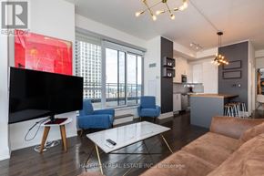 Toronto (Moss Park) condo for rent - A modern living room with a flat screen TV and a glass coffee table.