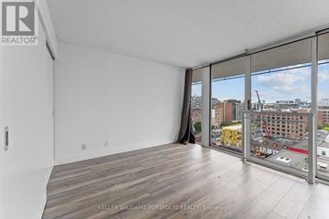 Toronto (Waterfront Communities) condo for rent - A room with a view of the cityscape through the windows.