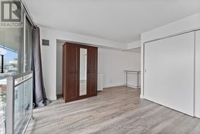 Toronto (Waterfront Communities) condo for rent - A room with a white wall and a wooden floor.