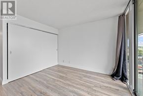 Toronto (Waterfront Communities) condo for rent - A room with a sliding door and a wooden floor.