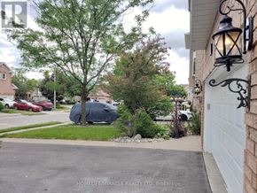 Brampton (Snelgrove) apartment for rent - A residential street with a house and parked cars.