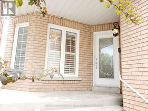 Brampton (Snelgrove) apartment for rent - A house with a white door and window with shutters.