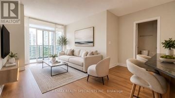 Mississauga (City Centre) condo for rent - A living room with a white couch and a coffee table.