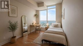 Mississauga (City Centre) condo for rent - A bedroom with a bed, desk, chair, and a potted plant.