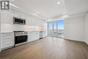 Waterloo condo for rent - A well-lit, spacious kitchen with white cabinets and a stainless steel oven.