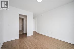 Waterloo condo for rent - A room with wooden flooring and white walls.
