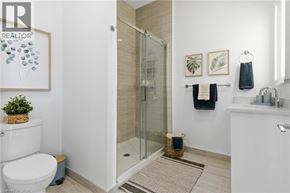 Waterloo condo for rent - A white toilet sits next to a glass shower stall in a bathroom.