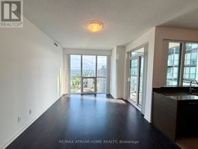 Toronto (Willowdale West) condo for rent - A spacious room with a view of the cityscape through the windows.