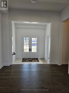 Oro-Medonte apartment for rent - A hallway with a door at the end and a sign on the wall.