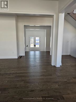 Oro-Medonte apartment for rent - A hallway with wood flooring and white walls.