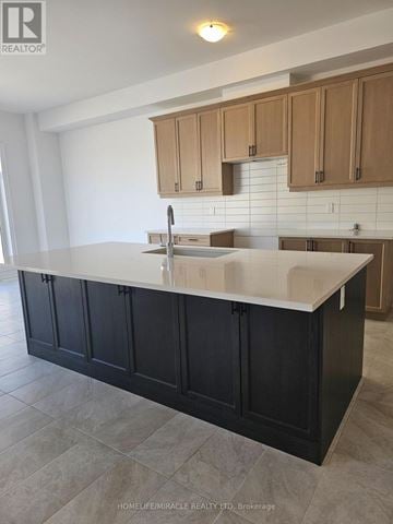 Oro-Medonte apartment for rent - A kitchen with a black counter and wooden cabinets.
