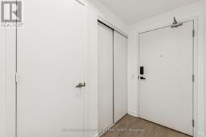 Mississauga (City Centre) condo for rent - A white door with a black handle is in a room with white walls.