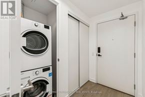 Mississauga (City Centre) condo for rent - A white washing machine is in a small laundry room.