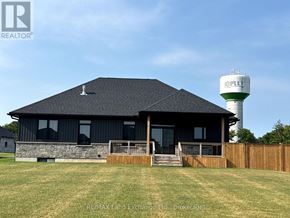 Huron-Kinloss apartment for rent - A house with a water tower in the background.